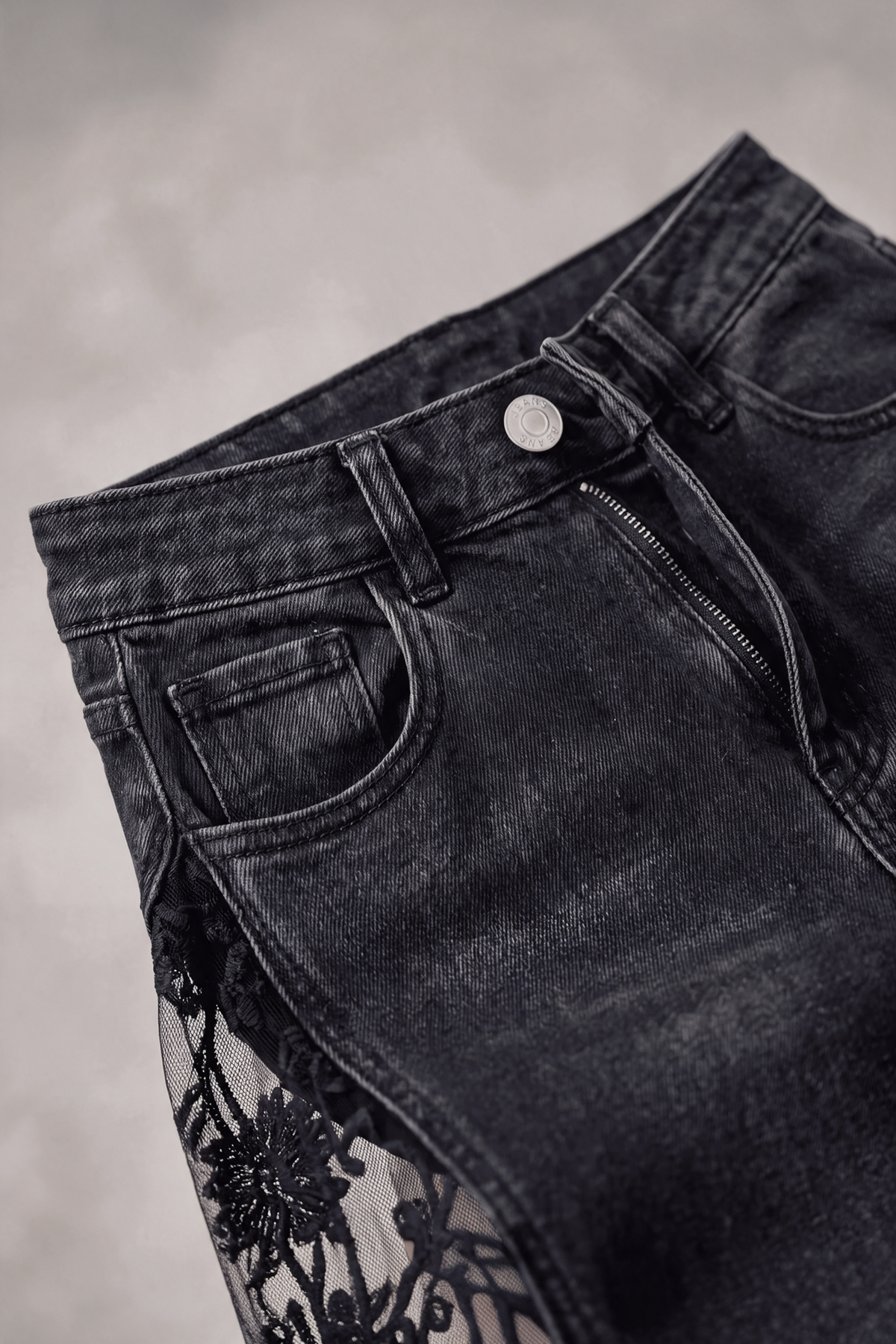 High-rise waist with button and zip on washed black denim